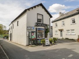 A building with a shop and signs at Burnside Cottage in Grange-Over-Sands