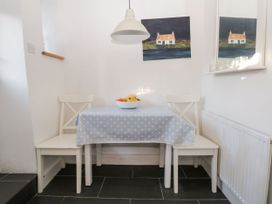 A dining area with a table and chairs at Burnside Cottage in Grange-Over-Sands
