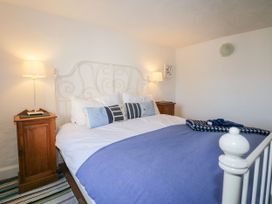 A bedroom with a bed and bedside tables at Burnside Cottage in Grange-Over-Sands