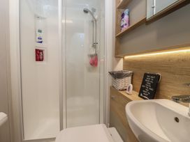 A bathroom with a shower, toilet, and sink at Lodge 22, Moselle Malton