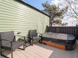 An outdoor area with a hot tub and seating at Lodge 22, Moselle in Malton