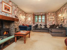 A living room with a fireplace and seating at West Down Country House in South Molton