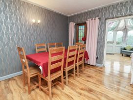 A dining room with a wooden table and chairs at West Down Country House in South Molton
