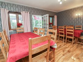 A dining room with a wooden table and chairs at West Down Country House in South Molton