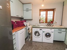 A laundry room with appliances and towels at West Down Country House in South Molton