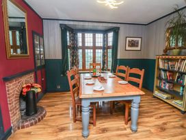 A dining room with a table and chairs at West Down Country House in South Molton
