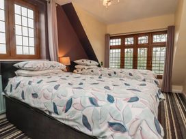 A bedroom with two beds and a window at West Down Country House in South Molton