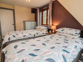 A bedroom with two beds and a window at West Down Country House in South Molton