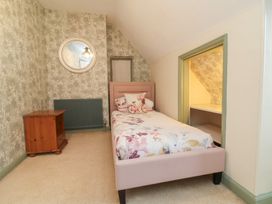 A bedroom with a bed and bedside table at West Down Country House in South Molton