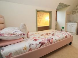 A bedroom with a bed and cabinet at West Down Country House in South Molton