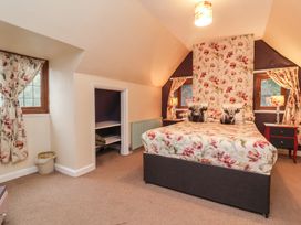 A bedroom with a bed and bedside tables at West Down Country House in South Molton