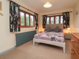 A bedroom with a bed and chest of drawers at West Down Country House in South Molton
