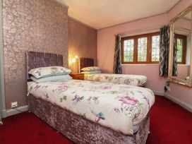 A bedroom with two beds and a window at West Down Country House in South Molton