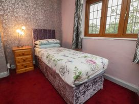 A bedroom with a single bed and bedside table at West Down Country House in South Molton