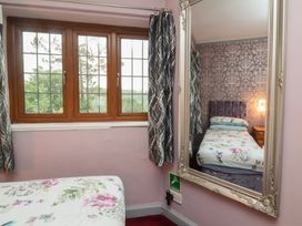 A bedroom with a bed and window at West Down Country House in South Molton