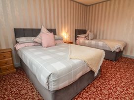 A bedroom with two beds and furniture at West Down Country House in South Molton
