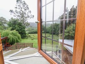 A view from an open window showing trees and a field at West Down Country House in South Molton