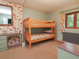 A bedroom with a bunk bed and a desk at West Down Country House in South Molton