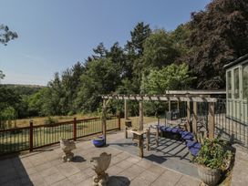 A garden with a pergola and benches at West Down Country House in South Molton