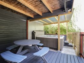 An outdoor area with a hot tub and a picnic table at West Down Country House in South Molton