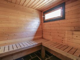 A sauna with wooden benches and a window at West Down Country House in South Molton