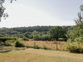 A field with trees and grass at West Down Country House South Molton