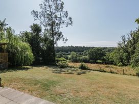 A garden with grass and trees at West Down Country House in South Molton