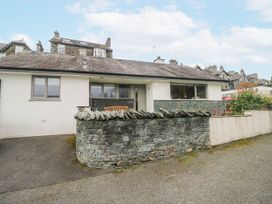 A house with a stone wall and garden at Ambwray in Ambleside