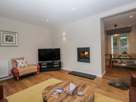 A living room with a television and fireplace at Ambwray in Ambleside