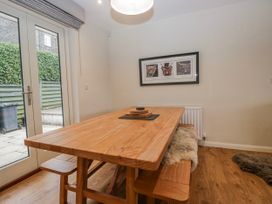 A dining room with a wooden table and benches at Ambwray in Ambleside