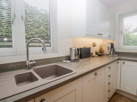 A kitchen with a sink and appliances at Ambwray in Ambleside