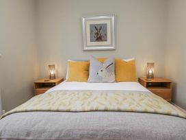 A bedroom with a bed and bedside tables at Ambwray in Ambleside