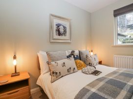 A bedroom with a bed and decorative pillows at Ambwray in Ambleside