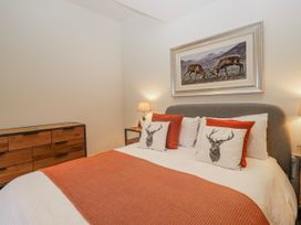 A bedroom with a bed and a picture at Ambwray in Ambleside