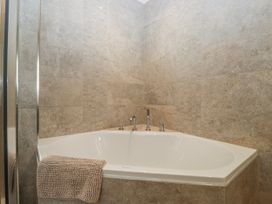 A bathtub with a towel in a bathroom at Ambwray in Ambleside