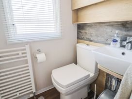 A bathroom with a toilet and sink at Bordeaux in Ladram Bay Otterton