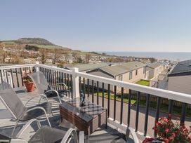 A balcony view overlooking the sea and hills at Bordeaux in Ladram Bay Otterton