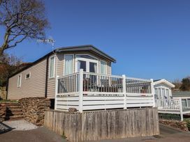 A mobile home with a deck and steps at Bordeaux in Ladram Bay Otterton