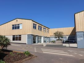 A building with a fish and chips sign at Ladram Bay Otterton