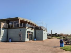 An outdoor area with a building and seating at Bordeaux Ladram Bay Otterton