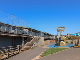 An outdoor area with a play structure and stairs at Bordeaux in Ladram Bay Otterton