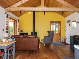 A living room with a sofa and chair at Nelli Lodge at Mile End in Crediton