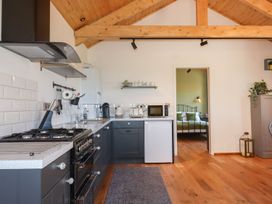 A kitchen with appliances and utensils at Nelli Lodge at Mile End in Crediton