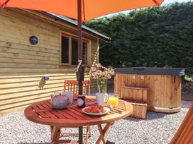 A table with breakfast items and a hot tub at Nelli Lodge at Mile End, Crediton