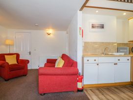 A living room with a sofa and armchair at Cottage 2 in Keswick