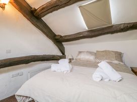 A bedroom with a bed and towels at Cottage 2 in Keswick