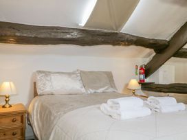 A bedroom with a bed and towels at Cottage 2 in Keswick