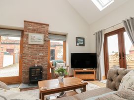 A living room with a television and fireplace at Bumble Bee Lodge in Filey