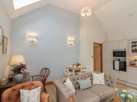 A living room with a sofa and table at Bumble Bee Lodge in Filey