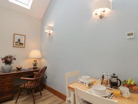A dining area with a table and chairs at Bumble Bee Lodge in Filey